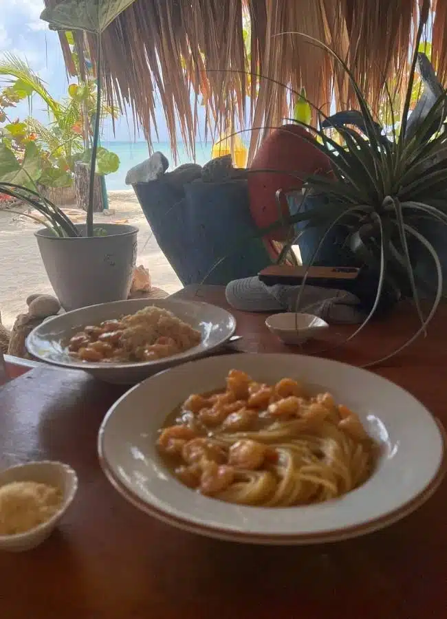 Plato de pasta con marisco servido en un restaurante frente al mar.