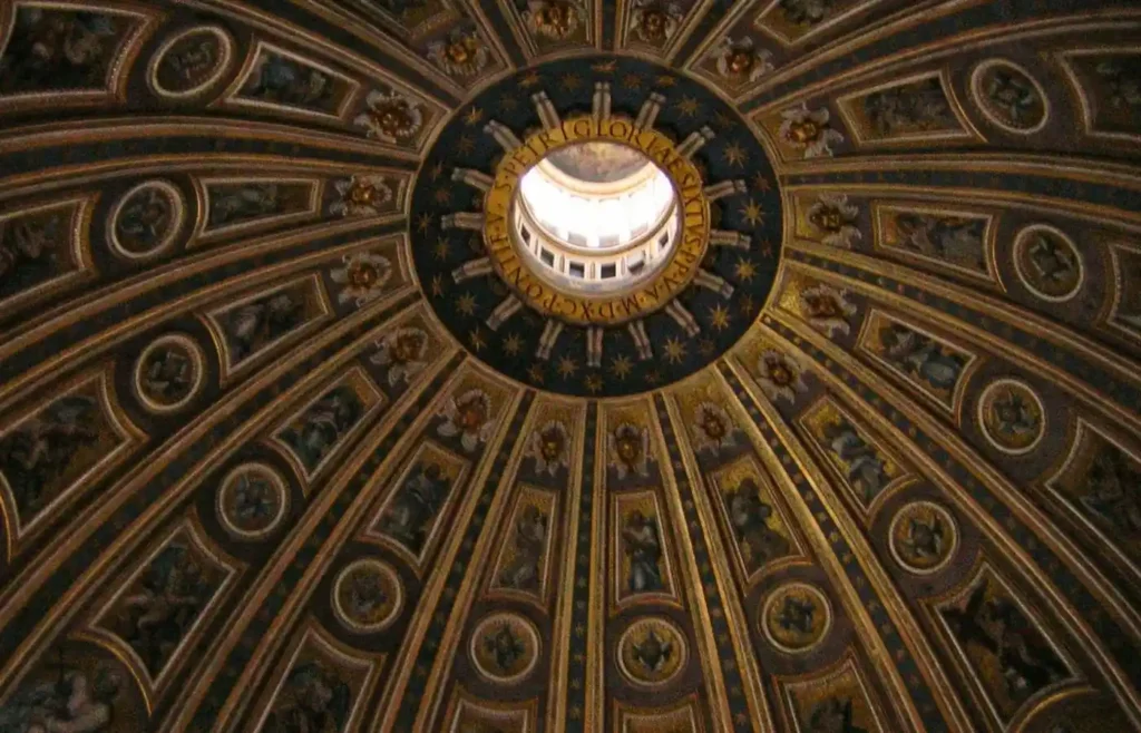 Cúpula barroca interior ricamente decorada con óculo central.