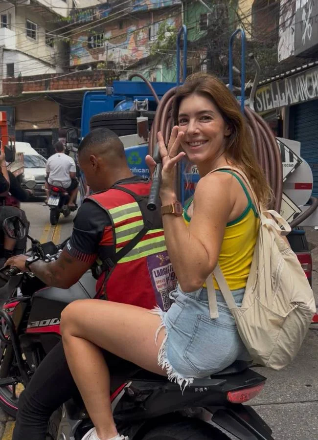 Mireia subiendo en moto-taxi por las empinadas calles de la Rocinha, una experiencia imprescindible al visitar la favela en Brasil.