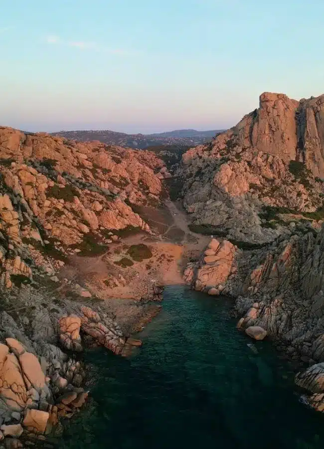 Toma de dron de un cañón de roca caliza estrecho que se abre paso hacia el mar de Cerdeña.