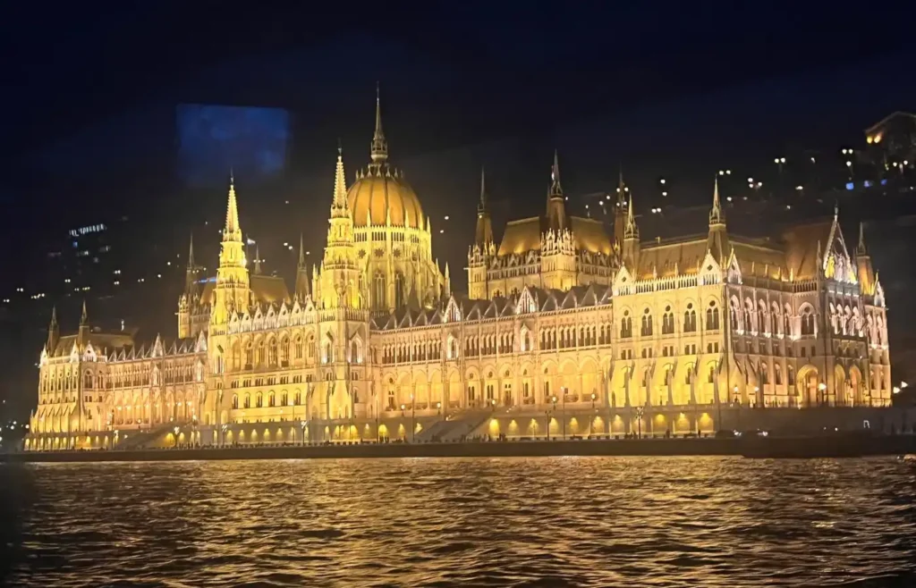 Reflexión del Parlamento de Budapest iluminado sobre el río Danubio