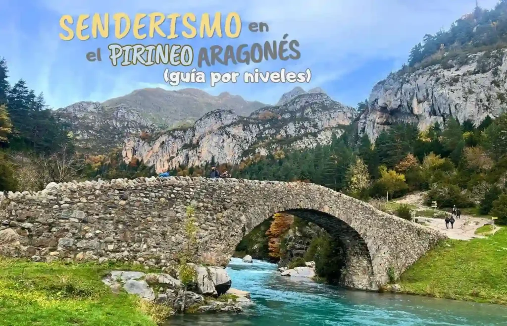 Puente de piedra sobre río turquesa en Pirineo Aragonés. Senderismo.