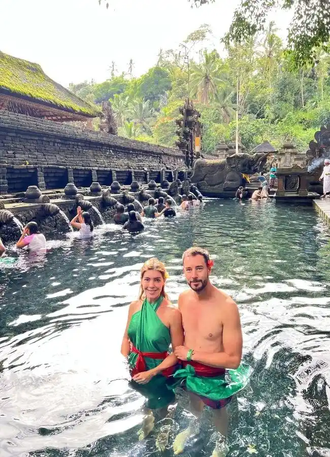 Pareja en las piscinas de agua sagrada del templo Tirta Empul en Bali, Indonesia.